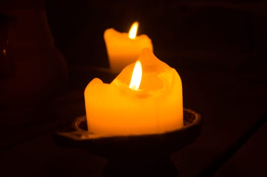 Burning candle in the dark