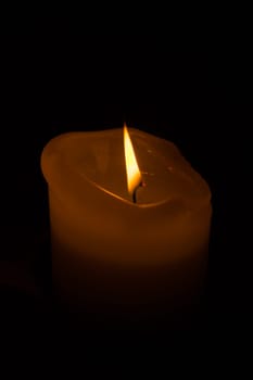 Burning candle in the dark