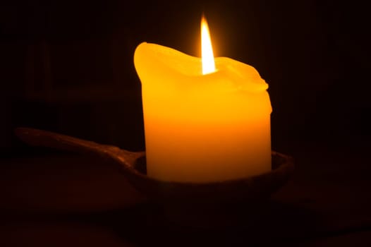 Burning candle in the dark