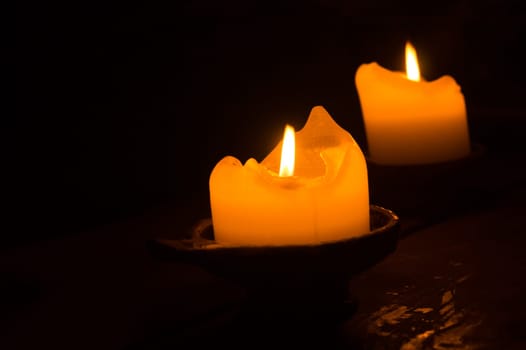 Burning candle in the dark