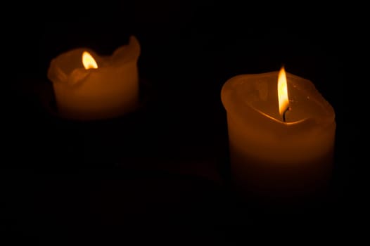 Burning candle in the dark