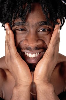 A smiling young African American man in close up holding booths hands.on his face, looking happy, isolated for white background.