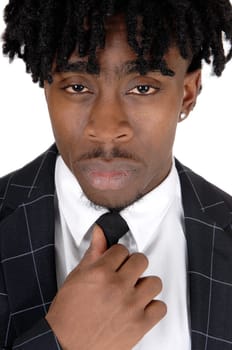 A close up image of an black man in a suit and white shirt and tie fixing.his tie with fussy black hair, isolated for white background.