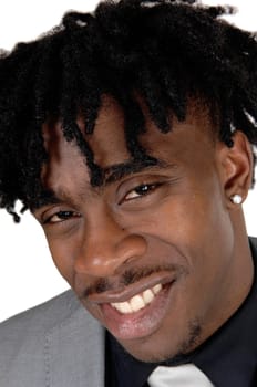 A happy African American mans face in a close up image with his fussy.black hair in a suit, isolated for white background.