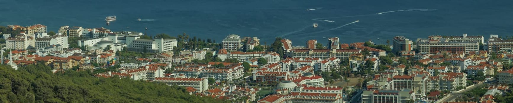Nature landscape with a city by the shore of the sea between the hills. mountain town panorama