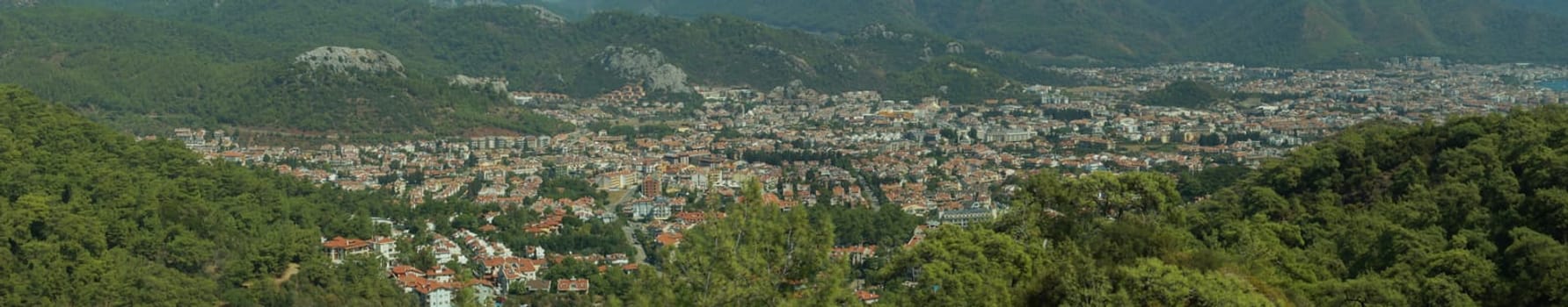 Mountain town panorama. landscape with a city between the hills