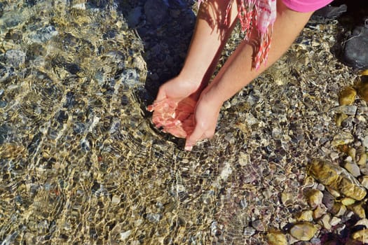 Woman hands on the water