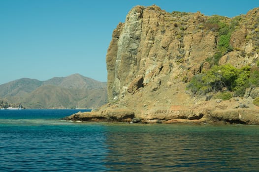 Mountain and sea. coastline with a rock