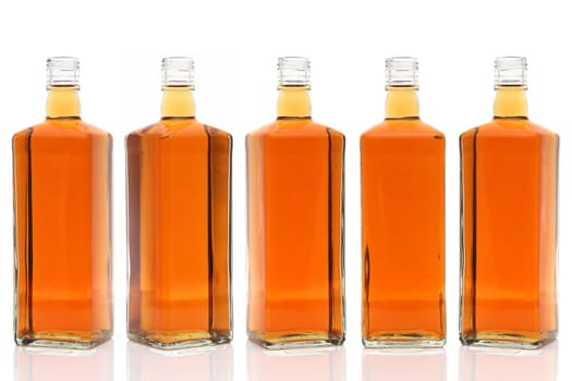 Row of glass bottle whiskey on a white background