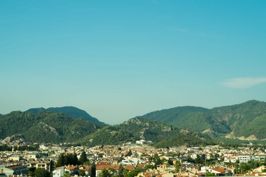 Mountain town panoramic view. landscape with a city between the hills