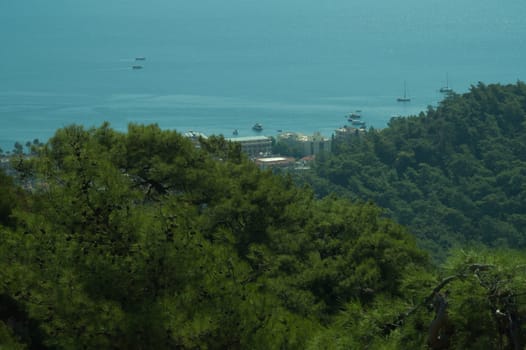 Nature landscape with a city by the shore of the sea between the hills. mountain town panoramic view