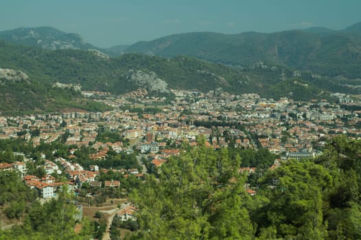 Mountain town panoramic view. landscape with a city between the hills