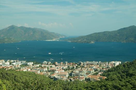 Nature landscape with a city by the shore of the sea between the hills. mountain town panoramic view