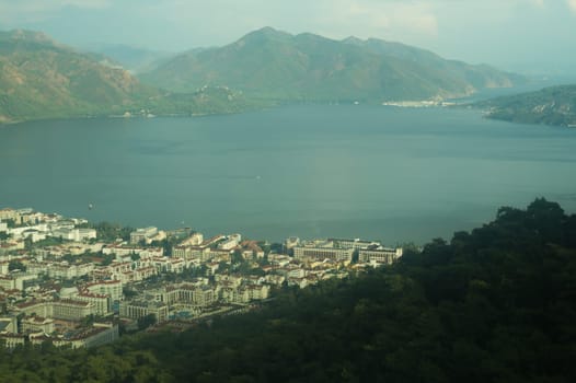 Nature landscape with a city by the shore of the sea between the hills. mountain town panoramic view