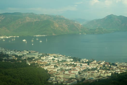 Nature landscape with a city by the shore of the sea between the hills. mountain town panoramic view
