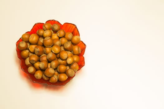 Hazelnuts in a bowl isolated on white. background with copy space