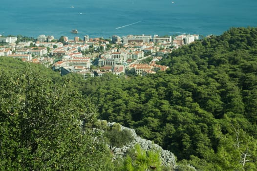 Nature landscape with a city by the shore of the sea between the hills. mountain town panoramic view