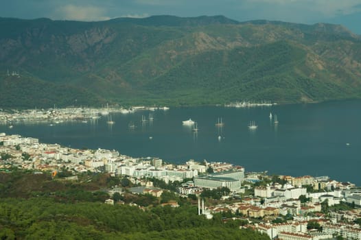 Nature landscape with a city by the shore of the sea between the hills. mountain town panoramic view