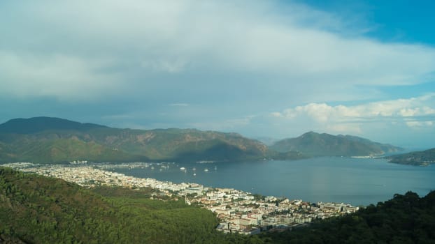 Nature landscape with a city by the shore of the sea between the hills. mountain town panoramic view