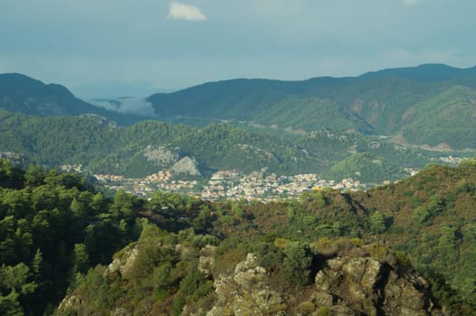 Mountain town panoramic view. landscape with a city between the hills