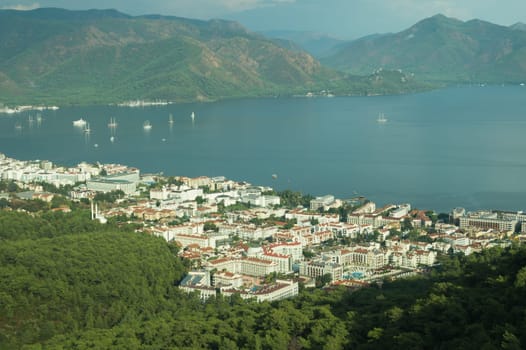 Nature landscape with a city by the shore of the sea between the hills. mountain town panoramic view