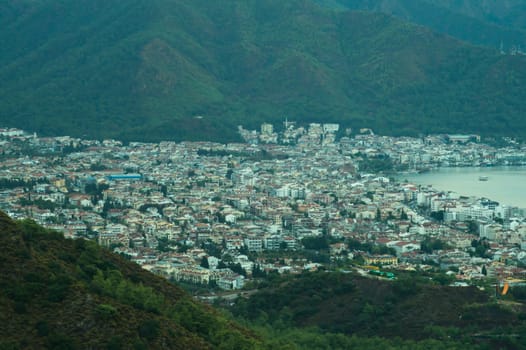 Nature landscape with a city by the shore of the sea between the hills. mountain town panoramic view