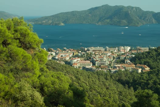 Nature landscape with a city by the shore of the sea between the hills. mountain town panoramic view