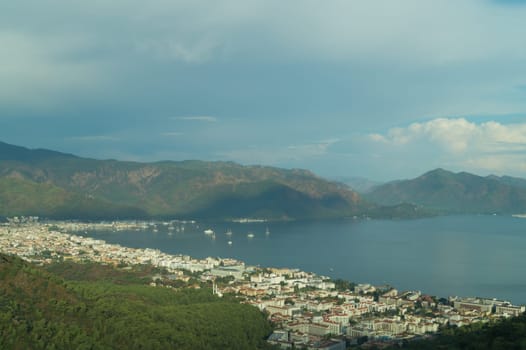 Nature landscape with a city by the shore of the sea between the hills. mountain town panoramic view