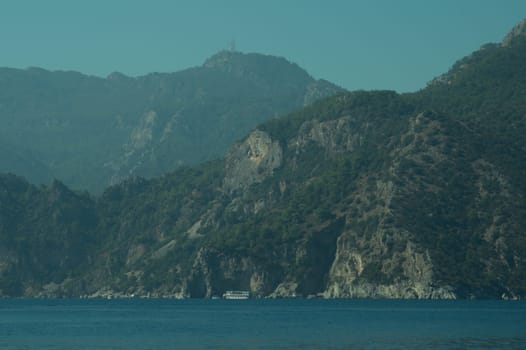 Recreation on the boat near the shore of a mountain