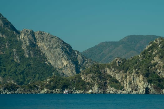 Recreation on the boat near the shore of a mountain