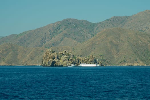 Recreation on the boat near the shore of a mountain