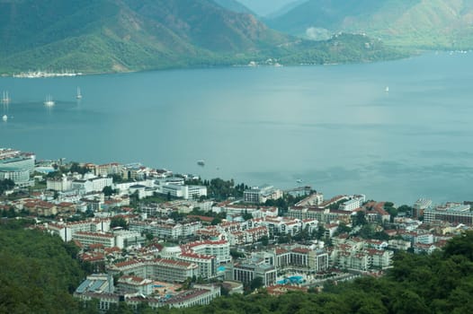 Nature landscape with a city by the shore of the sea between the hills. mountain town panoramic view