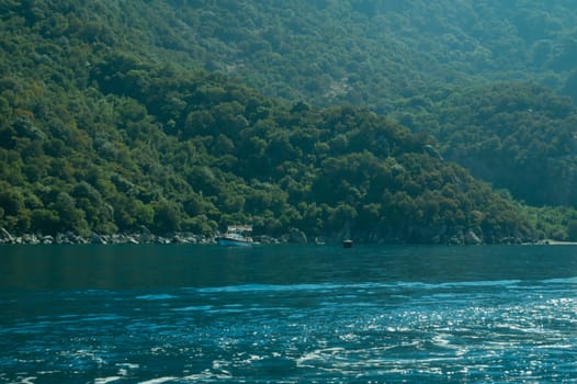 Recreation on the boat near the shore of a mountain
