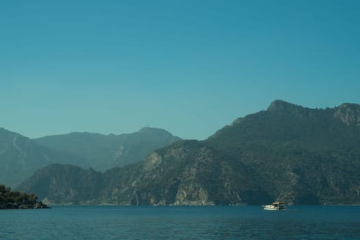 Recreation on the boat near the shore of a mountain