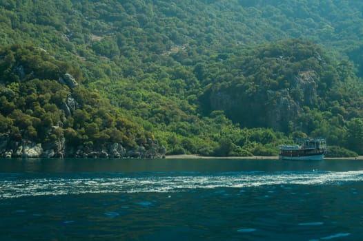 Recreation on the boat near the shore of a mountain