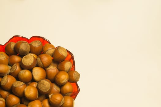 Hazelnuts in a bowl isolated on white. background with copy space