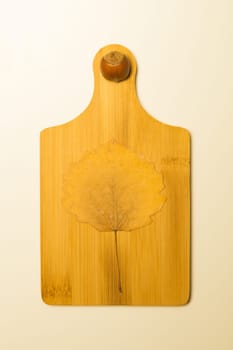 Hazelnut and autumn leaf on a wooden board background