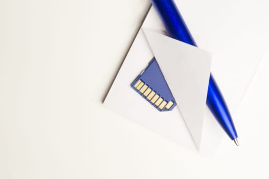 Memory card and blue pen with the paper background