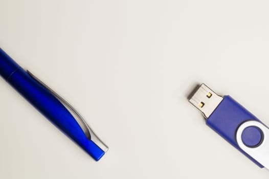 Usb flash drive and blue pen isolated on white background. copy space
