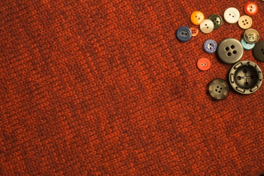 Various sewing buttons on textile background. copy space