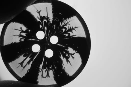 Transparent button with pattern. macro view. black silhouette