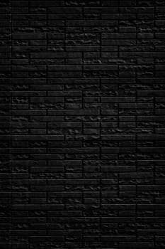 Abstract black brick wall texture background. Vertical view of masonry brick wall for interior design.