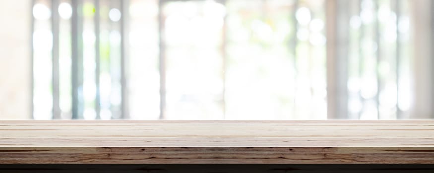 Empty wooden table top with blur office interior background, Panoramic banner. Abstract background can be used for display or montage your products.