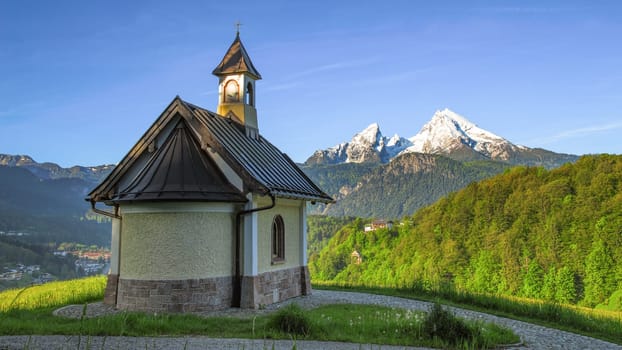 Panoramic spring view beside Berchtesgaden township with mount Watzmann and traditional Kirchleitn chapel
