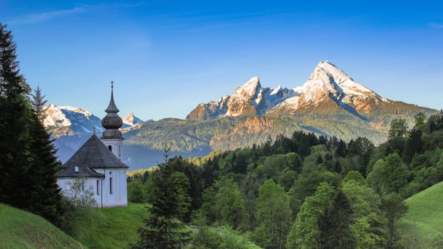 Destination scenery in Bavarian national park Berchtesgaden with Maria Gern chapel and snowy Watzmann mountain