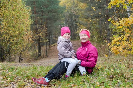 Grandmother with her granddaughter in the autumn park