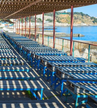 Old wooden deck-chairs on the beach of Crimea. Ukraine