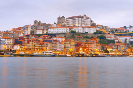 Scenic evening Porto cityscape with Douro embankment and illuminated old town architecture, Portugal