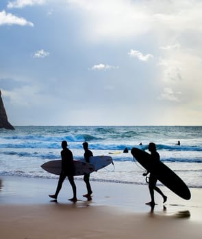 Group of surfers with surfboards on the beach. Algarve, Portugal