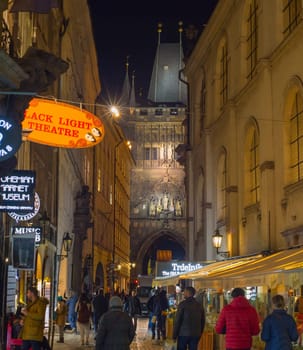 RRAGUE, CZECH REPUBLIC - NOVEMBER 13, 2018: Peope walking by Old Town street of Prague heading to Charles Bridge.